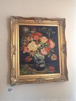 Full view of framed floral oil painting on wall