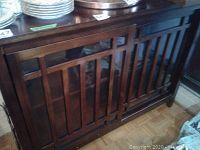 Front view of sideboard showing two sliding lattice wood-frame glass doors