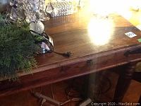 Full front view of desk with decorative items removed, showing overall shape and finish