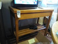 Full view of wooden butcher block rolling cart showing top and lower slatted shelf with contents removed.