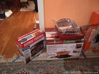 Photo of George Foreman grill box and Copper Chef cookware on induction cooktop box