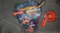 Photo shows a yellow and orange Nerf toy gun, a circular Nerf target, an orange drum magazine, and multiple foam darts scattered around.