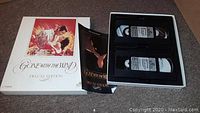 White box with Gone with the Wind artwork and two VHS tapes inside, alongside a folded insert booklet.