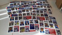 Photo showing multiple pages covered with New York Giants collectible stickers featuring players and promotional images.