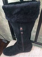 Single black suede Geox boot showing faux fur lining folded at top and side zipper with silver button pulls.