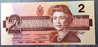 Front side of the 1986 Canadian two dollar bill showing Queen Elizabeth II and denomination details.