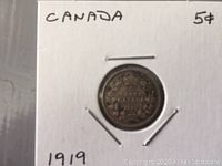 Photo of 1919 Canadian Small Nickel 5 cent coin mounted in a white cardboard holder with handwritten text indicating denomination, country, and year.