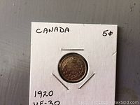 Photo of the 1920 Canadian nickel 5-cent coin with handwritten label showing year and grade VF-30.