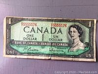 Front side of a 1954 Canadian one dollar bill showing a green design with a portrait of Queen Elizabeth II and serial number 255555576 in red.