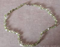 Full view of the necklace laid flat showing the entire length and the clasp.