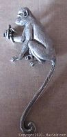 Front view of the vintage pewter monkey brooch showing detailed sculpting and design.