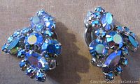 Front view of blue aurora borealis clip earrings showing prong set marquise and round crystal stones.