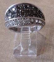 Front view of the wide sterling silver ring showing rows of black and clear stones.