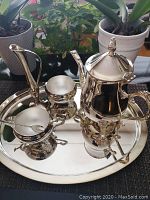 Overview of the 6-piece silver plated tea set on the tray showing all pieces.