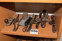 Shelf holding block plane, two sharpening stones, and four spokeshaves