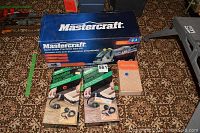 Mastercraft saw kit box, two adjustable band clamps in packaging, Chicago Specialty flaring tool box and flaring tool parts.
