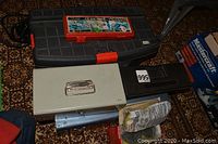 Two toolboxes (plastic and metal) with some tools and accessories around them.