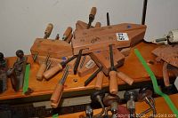 Four Craftsman wood gluing clamps arranged on a wooden shelf