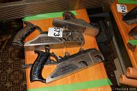 Three metal hand planes on a wooden table