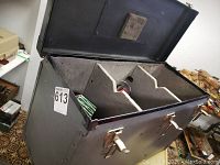 Open tackle case showing multiple reels and two line spools