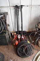 Photo of 4 tonne and 8 tonne hydraulic bottle jacks with 2 tonne trolley jack, extension cord coiled in front