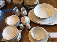 Full set of Mikasa Bridal Veil china pieces including plates, bowls, serving bowls, salt and pepper shakers, creamer, and sugar bowl laid out on a table.