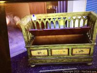 Front view with bench lid open showing storage compartment and fruit design on front panels