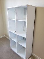 White wood cubby shelf with six compartments, adjustable shelves, and white painted finish.