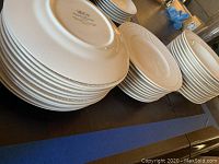 Stacked Mikasa shallow soup bowls showing markings on the bottom and rim detail.