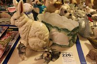 Large white rabbit figurine, Scottish terrier dog figurines, and decorative ceramic bowl with rabbit images on table
