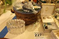 View of crystal figurines, trinket box, and basket on table with jewelry nearby