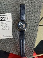 Full view of the Citizen Navihawk Blue Angels watch laying flat, showing leather strap and watch face.