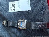 Full view of watch laid flat with lot tag