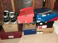 Two columns of nine stacked shoe boxes showing brands Clarks, Nike, Reebok, Asics, Dr. Martens and others
