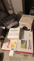 Overview of lot showing Canon printer box, Apple AirPort Extreme box, Apple Time Capsule box and slide viewer box