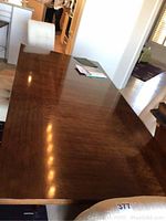 Top view of tabletop surface showing wood grain and dark brown finish