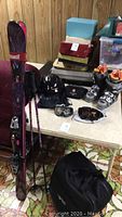 Overview of full lot: skis, poles, boots, helmet, goggles, bag
