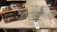 Table display with Conair Extreme Steam Fabric Steamer boxed product, two wire baskets with handles, and steamer metal accessories