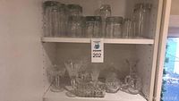 Full view of shelves holding the glassware and crystal kitchen items for visual context