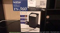 Boxes showing VuPoint digital film scanner and Brother TN-360 toner cartridge together for lot identification.