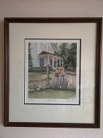 Full view of framed lithograph showing children eating yogurt cones sitting on rock in front of house and greenery