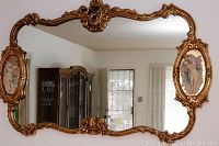 Front view of mirror on wall showing overall shape and reflection