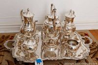 Full view of Sheridan 6-piece silver plated tea set arranged on ornate tray, showing teapots, sugar bowl, creamer, and platter