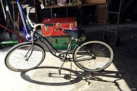 Full side profile of black Schwinn cruiser bicycle showing 26 inch wheels and cruiser style frame