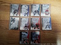 Front side of 11 hockey cards featuring goalies with masks and team uniforms.