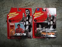 Front view of the two Johnny Lightning Elvis Presley matchbox cars in original packaging, showing car details and packaging artwork including Elvis Presley images.