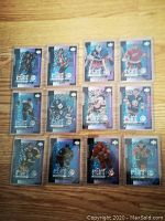Twelve Upper Deck E-Card hockey insert cards from 2000/2001 season arranged in 3 rows of 4 cards each, showing holographic blue backgrounds and various players.