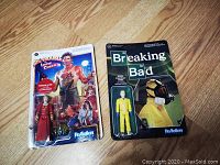 Front view of two unopened Funko ReAction Figures in blister packaging: Jesse Pinkman from Breaking Bad and Gracie Law from Big Trouble in Little China.