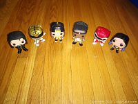 Full set of six Funko Pop! vinyl figurines arranged in a line on wooden floor, showing all characters' front and top details.