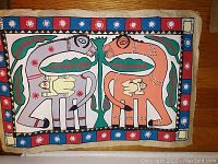 Front view of vintage Indigenous Australian artwork on papyrus depicting two stylized animals in complementary colors with dot pattern border.